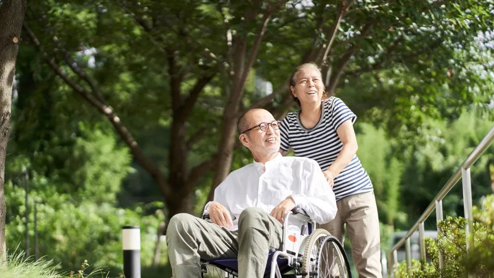 Family supporting the elderly in wheelchairs