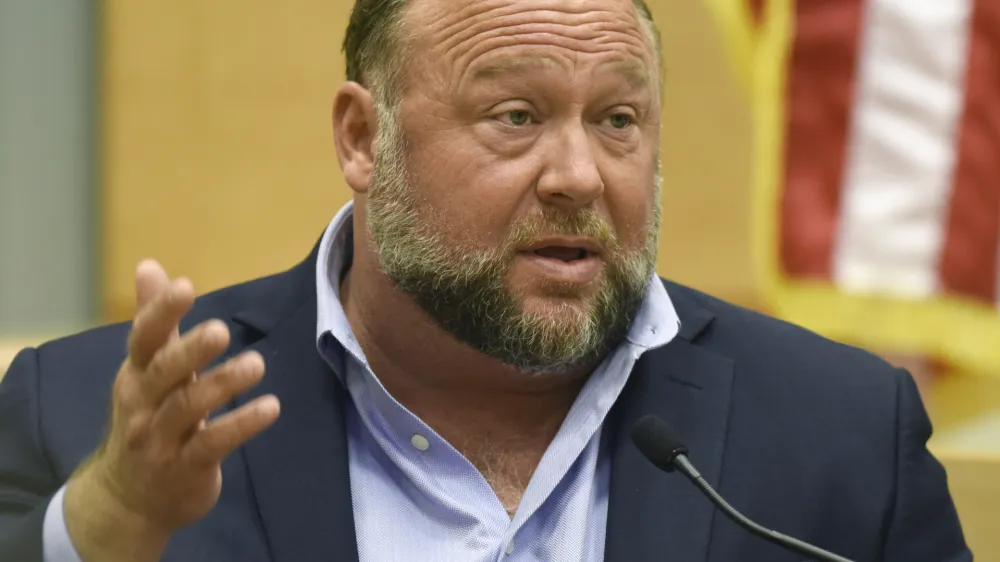 FILE - Infowars founder Alex Jones testifies at the Sandy Hook defamation damages trial at Connecticut Superior Court in Waterbury, Conn., on Thursday, Sept. 22, 2022. A six-person jury reached a verdict Wednesday, Oct. 12, 2022, saying that Jones should pay $965 million to 15 plaintiffs who suffered from his lies about the Sandy Hook school massacre. Jones and his company were found liable for damages last year. (Tyler Sizemore/Hearst Connecticut Media via AP, Pool, File)