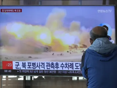 A TV screen shows a file image of North Korea's military exercise during a news program at the Seoul Railway Station in Seoul, South Korea, Wednesday, Oct. 19, 2022. North Korea fired artillery shells near its sea boundaries with South Korea late Tuesday, a day after the South began annual military drills to better deal with North Korean provocations. (AP Photo/Ahn Young-joon)