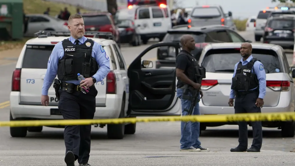 Law enforcement investigate the scene of a shooting at Central Visual and Performing Arts High School Monday, Oct. 24, 2022, in St. Louis. (AP Photo/Jeff Roberson)