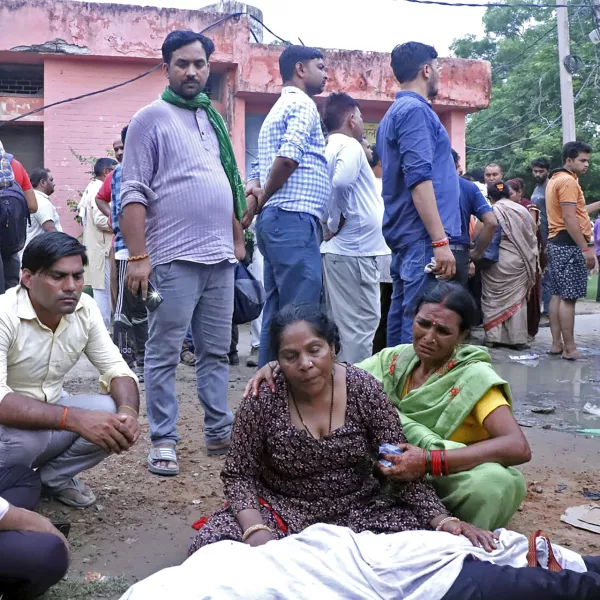 Women mourn next to the body of a relative outside the Sikandrarao hospital in Hathras district about 350 kilometers (217 miles) southwest of Lucknow, India, Tuesday, July 2, 2024. At least 60 people are dead and scores are injured after a stampede at a religious gathering of thousands of people in northern India, officials said Tuesday.(AP Photo/Manoj Aligadi)