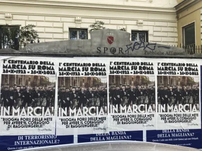 Posters commemorating the 100th anniversary of the March on Rome bearing a picture of Italian Fascist Dictator Benito Mussolini reading: "Marching!" with a quote by Mussolini "you have to set yourself goals to have the courage to reach them" are posted on the Rome's public billboard space, Thursday, Oct. 27, 2022. (AP Photo/Gregorio Borgia)