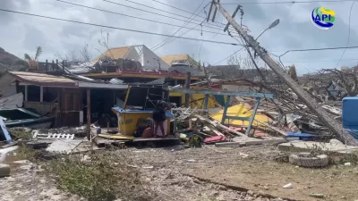 A person stands amidst damaged property following the passing of Hurricane Beryl, in Union Island, Saint Vincent and the Grenadines, in this screen grab taken from a handout video released on July 2, 2024. The Agency For Public Information St. Vincent and the Grenadines/Handout via REUTERS  THIS IMAGE HAS BEEN SUPPLIED BY A THIRD PARTY. NO RESALES. NO ARCHIVES. MANDATORY CREDIT