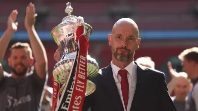 FILE - Manchester United's head coach Erik ten Hag celebrates with the trophy after winning the English FA Cup final soccer match between Manchester City and Manchester United at Wembley Stadium in London, on May 25, 2024. Manchester United manager Erik ten Hag has signed a contract extension through to 2026, the Premier League club said. (AP Photo/Ian Walton)