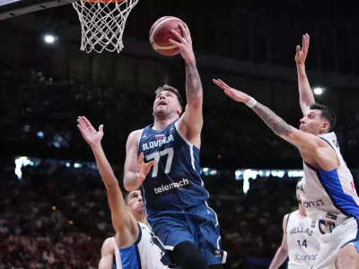 Slovenia's Luka Doncic tries to score against Greece, during an Acropolis tournament basketball match, at the Peace and Friendship indoor stadium at Athens' port city of Piraeus, Saturday, July 6, 2024. (AP Photo/Petros Giannakouris)