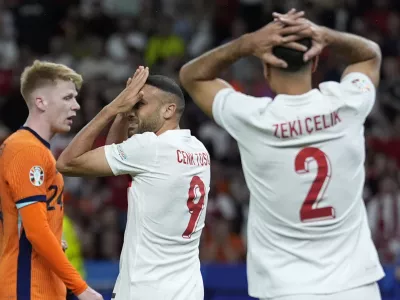 Turkey's Cenk Tosun, center, reacts during a quarterfinal match between the Netherlands and Turkey at the Euro 2024 soccer tournament in Berlin, Germany, Saturday, July 6, 2024. (AP Photo/Ariel Schalit)