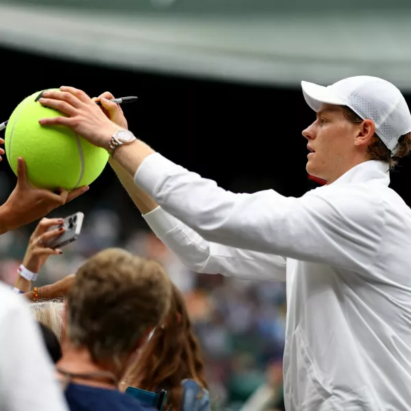 Tennis - Wimbledon - All England Lawn Tennis and Croquet Club, London, Britain - July 7, 2024 Italy's Jannik Sinner signs autographs for fans after winning his fourth round match against Ben Shelton of the U.S. REUTERS/Hannah Mckay