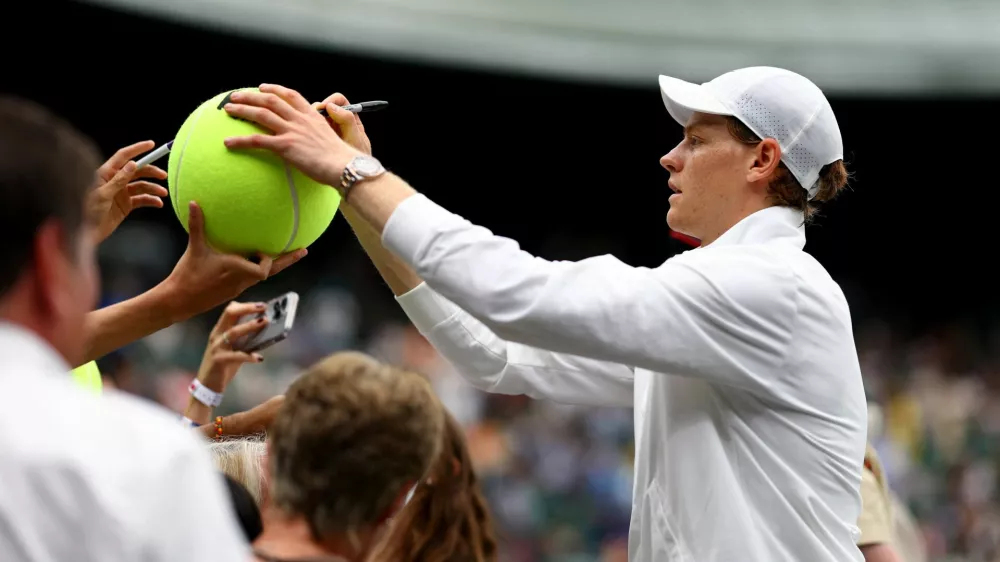 Tennis - Wimbledon - All England Lawn Tennis and Croquet Club, London, Britain - July 7, 2024 Italy's Jannik Sinner signs autographs for fans after winning his fourth round match against Ben Shelton of the U.S. REUTERS/Hannah Mckay