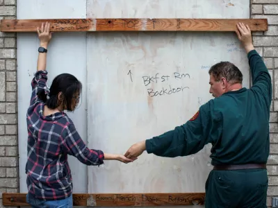 Shan Mei Martinez and Mario Martinez attach door braces to secure their back bay-facing door, as residents prepare for the arrival of Hurricane Beryl in Port Lavaca, Texas, U.S. July 7, 2024. REUTERS/Kaylee Greenlee Beal