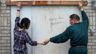 Shan Mei Martinez and Mario Martinez attach door braces to secure their back bay-facing door, as residents prepare for the arrival of Hurricane Beryl in Port Lavaca, Texas, U.S. July 7, 2024. REUTERS/Kaylee Greenlee Beal