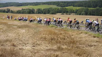 The pack rides during the ninth stage of the Tour de France cycling race over 199 kilometers (123.7 miles) with start and finish in Troyes, France, Sunday, July 7, 2024. (AP Photo/Jerome Delay)