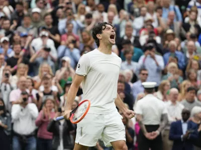 Taylor Fritz of the United States celebrates after defeating Alexander Zverev of Germany in their fourth round match at the Wimbledon tennis championships in London, Monday, July 8, 2024. (AP Photo/Kirsty Wigglesworth)