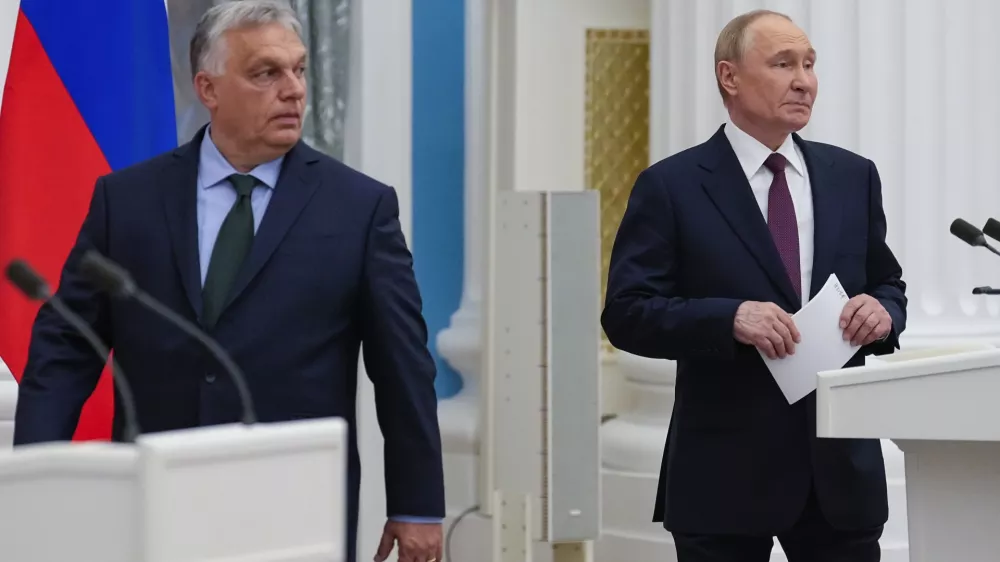 Russian President Vladimir Putin, right, and Hungarian Prime Minister Viktor Orban arrive to make press statements after their talks in the Kremlin in Moscow, Russia, Friday, July 5, 2024. Hungarian Prime Minister Viktor Orban visited Moscow on Friday for a rare meeting by a European leader with Russian President Vladimir Putin and discussed peace proposals for Ukraine, which triggered condemnation from Kyiv and some European leaders and officials. (AP Photo/Alexander Zemlianichenko)