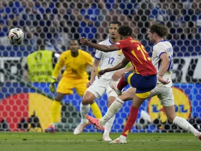 Spain's Lamine Yamal, center, scores his side's first goal during a semifinal match between Spain and France at the Euro 2024 soccer tournament in Munich, Germany, Tuesday, July 9, 2024. (AP Photo/Matthias Schrader)