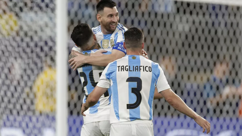 Argentina's Lionel Messi is congratulated after scoring his side's second goal against Canada during a Copa America semifinal soccer match in East Rutherford, N.J., Tuesday, July 9, 2024. (AP Photo/Adam Hunger)