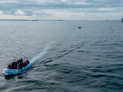 FILE PHOTO: In this drone view two inflatable dinghies carrying migrants pass a French navy vessel as they make their way towards England in the English Channel, Britain, May 4, 2024. REUTERS/Chris J. Ratcliffe/File Photo