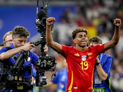 Spain's Lamine Yamal reacts after a semifinal match between Spain and France at the Euro 2024 soccer tournament in Munich, Germany, Tuesday, July 9, 2024. Left Spain's Rodri. (AP Photo/Hassan Ammar)