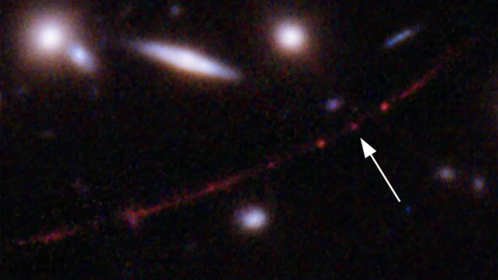 This image made available by NASA on Wednesday, March 30, 2022, shows the star Earendel, indicated by arrow, and the Sunrise Arc galaxy, stretching from lower left to upper right, optically bent due to a massive galaxy cluster between it and the Hubble Space Telescope which captured the light. The mass of the galaxy cluster serves as a magnifying glass, allowing Earendel to be seen. (NASA, ESA, Brian Welch (JHU), Dan Coe (STScI); Image processing: NASA, ESA, Alyssa Pagan (STScI) via AP)