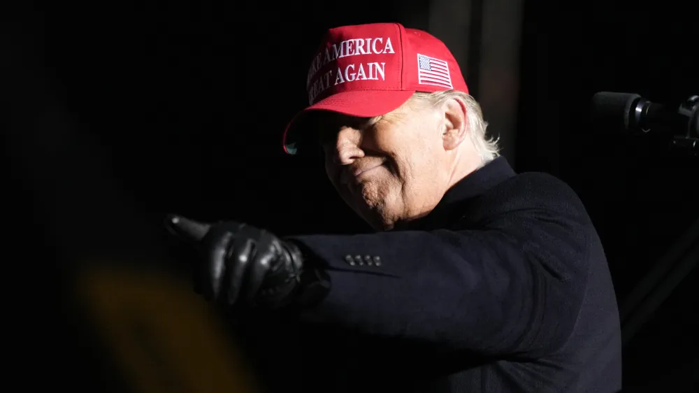 Former President Donald Trump reacts to a supporter during a rally, Thursday, Nov. 3, 2022, in Sioux City, Iowa. (AP Photo/Charlie Neibergall)