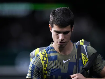 Spain's Carlos Alcaraz leaves the court after his withdrawal of the tournament during his quarterfinal match of the Paris Masters tennis tournament against Holger Rune from Denmark, at the Accor Arena, Friday, Nov. 4, 2022 in Paris. (AP Photo/Thibault Camus)