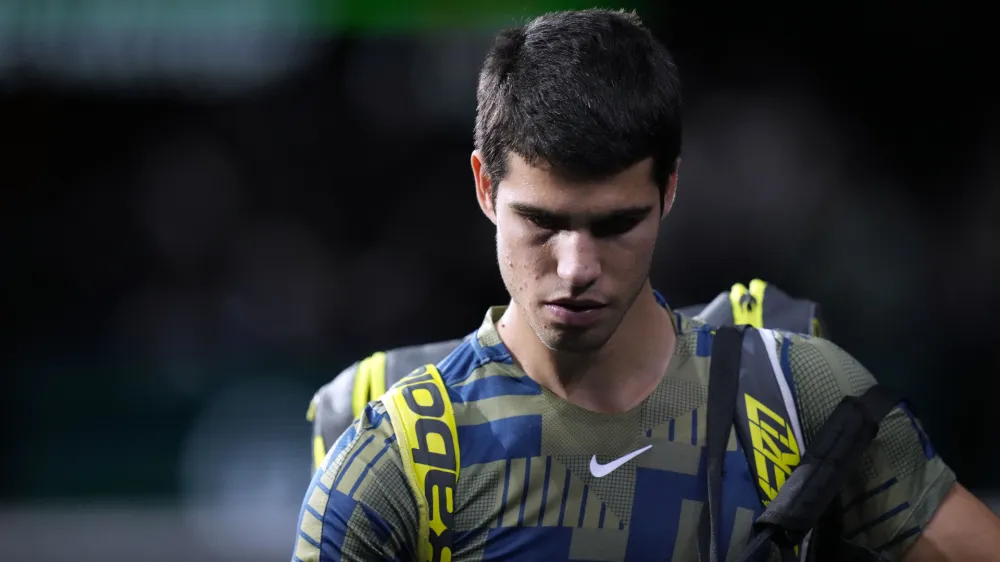 Spain's Carlos Alcaraz leaves the court after his withdrawal of the tournament during his quarterfinal match of the Paris Masters tennis tournament against Holger Rune from Denmark, at the Accor Arena, Friday, Nov. 4, 2022 in Paris. (AP Photo/Thibault Camus)