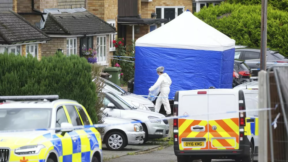 A forensic officer at the scene in Ashlyn Close, Bushey, after an incident on Tuesday evening, in Hertfordshire, England, Wednesday, July 10, 2024. British police were hunting for a man believed to be armed with a crossbow after three women were killed in a house near London. Hertfordshire Police said Kyle Clifford, 26, was being sought over the suspected triple murder. (Jacob King/PA via AP)