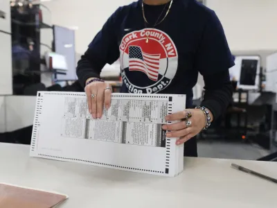 A worker sorts through ballots in the delayed processing at the Clark County Election Department for the Nevada midterm elections in Las Vegas, Nevada, U.S. November 9, 2022. REUTERS/David Swanson