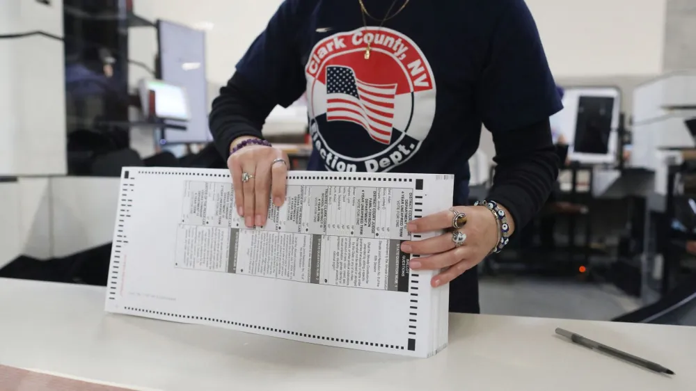 A worker sorts through ballots in the delayed processing at the Clark County Election Department for the Nevada midterm elections in Las Vegas, Nevada, U.S. November 9, 2022. REUTERS/David Swanson