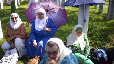 Bosnian muslim women wait for the mass burial ceremony, at the Srebrenica Memorial Centre, in Potocari, Bosnia, Thursday, July 11, 2024. Thousands gather in the eastern Bosnian town of Srebrenica to commemorate the 29th anniversary on Monday of Europe's only acknowledged genocide since World War II. (AP Photo/Armin Durgut)