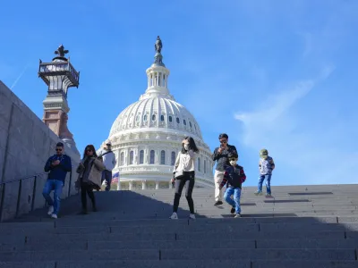 With the U.S Capitol in the background, people walk down steps on Election Day in Washington, Tuesday, Nov. 8, 2022. (AP Photo/Mariam Zuhaib)