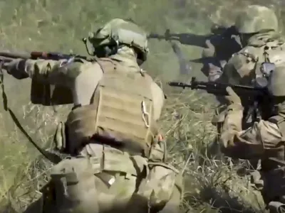 FILE - In this handout photo taken from video released by Russian Defense Ministry Press Service on Sept. 19, 2022, members of a special forces unit of the Russian army aim their weapons in action at an unspecified location in Ukraine. Even as the Kremlin moved to absorb four Ukrainian regions in a sharp escalation of the conflict, the Russian military suffered new stinging defeats that highlighted its deep problems.(Russian Defense Ministry Press Service via AP, File)