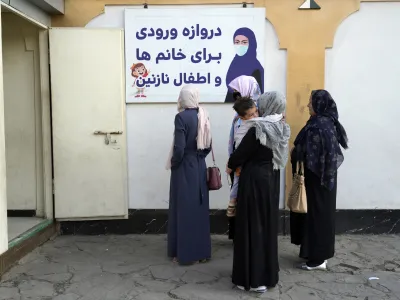 Afghan women stand outside an amusement park, in Kabul, Afghanistan, Thursday, Nov. 10, 2022. The Taliban have banned women from using gyms and parks in Afghanistan, Thursday, Nov. 10. The rule, which comes into force this week, is the group's latest edict cracking down on women's rights and freedoms. (AP Photo/Ebrahim Noroozi)