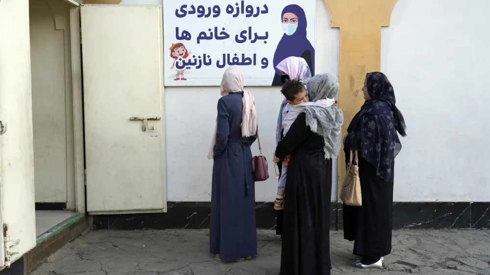 Afghan women stand outside an amusement park, in Kabul, Afghanistan, Thursday, Nov. 10, 2022. The Taliban have banned women from using gyms and parks in Afghanistan, Thursday, Nov. 10. The rule, which comes into force this week, is the group's latest edict cracking down on women's rights and freedoms. (AP Photo/Ebrahim Noroozi)