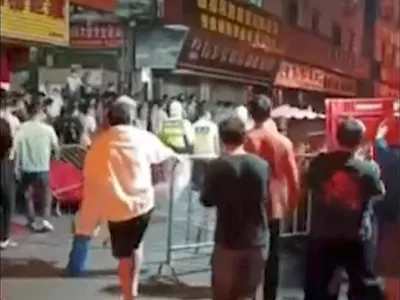 People protest in Guangzhou, China, in this still image obtained from a video released November 15, 2022. Video obtained by Reuters/via REUTERS THIS IMAGE HAS BEEN SUPPLIED BY A THIRD PARTY. NO RESALES. NO ARCHIVES