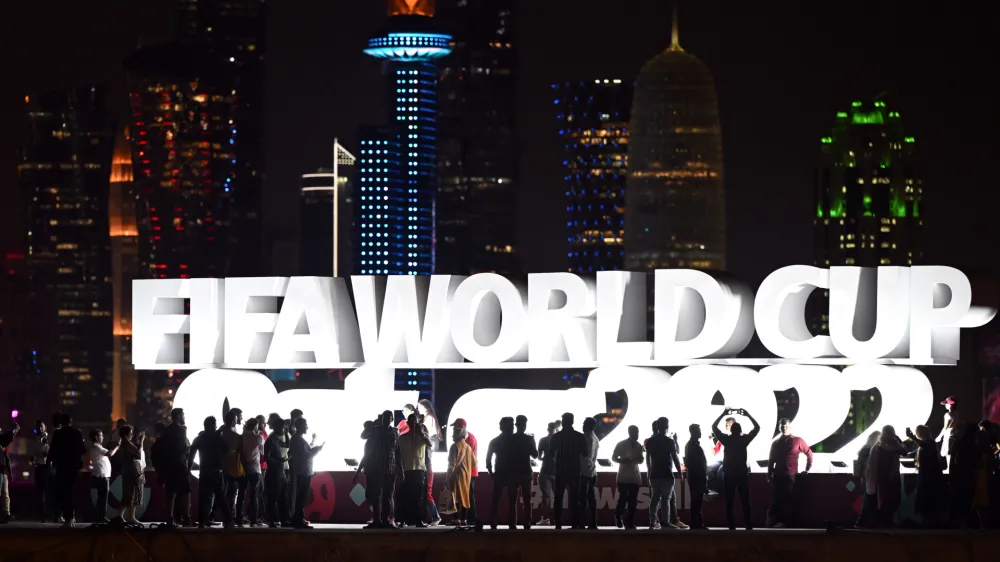 16 November 2022, Qatar, Doha: Fans stand in front of the sign "Fifa Wordcup Qatar 2022" sign at the Doha Corniche ahead of the 2022 FIFA Qatar World Cup. Photo: Federico Gambarini/dpa