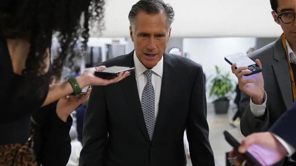 Sen. Mitt Romney, R-Utah, speaks with members of the press before voting on a bill that would enshrine same-sex and interracial marriages into federal law, Wednesday, Nov. 16, 2022, on Capitol Hill in Washington. (AP Photo/Patrick Semansky)