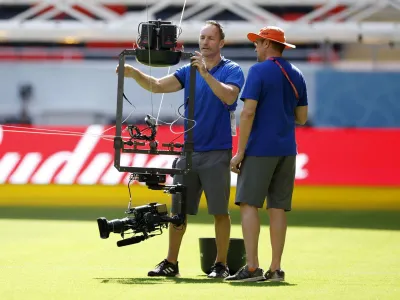 Soccer Football - FIFA World Cup Qatar 2022 - United States team stadium familiarization - Ahmad Bin Ali Stadium, Al Rayyan, Qatar - November 17, 2022 Camera operators work on a spider camera during the United States team stadium familiarization REUTERS/John Sibley