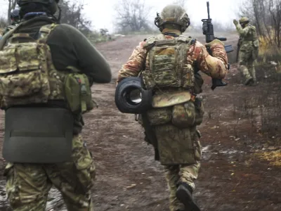 Ukrainian soldiers change their position at an undisclosed location in the Donetsk region, Ukraine, Thursday, Nov. 17, 2022. (AP Photo/Roman Chop)