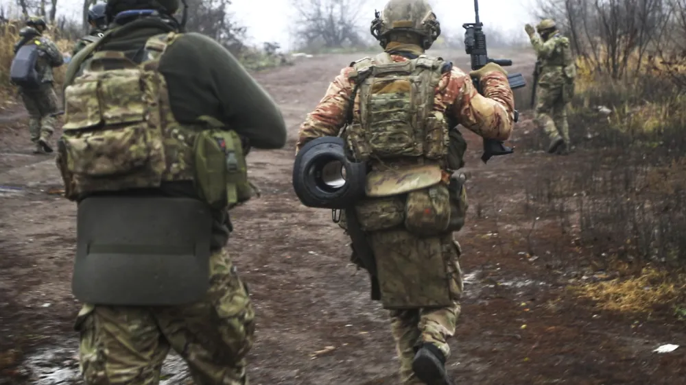 Ukrainian soldiers change their position at an undisclosed location in the Donetsk region, Ukraine, Thursday, Nov. 17, 2022. (AP Photo/Roman Chop)