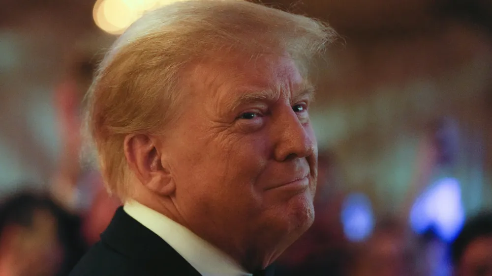 Former President Donald Trump smiles toward guests, as he arrives to speak at an event at Mar-a-Lago, Friday, Nov. 18, 2022, in Palm Beach, Fla. Earlier in the day Attorney General Merrick Garland named a special counsel to oversee the Justice Department's investigation into the presence of classified documents at Trump's Florida estate and aspects of a separate probe involving the Jan. 6, 2021, insurrection and efforts to undo the 2020 election. (AP Photo/Rebecca Blackwell)