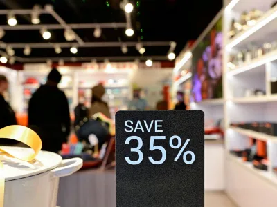 FILE PHOTO: People walk around a shop while a discount sign is seen outside as Black Friday sales begin at The Outlet Shoppes of the Bluegrass in Simpsonville, Kentucky, U.S., November 26, 2021. REUTERS/Jon Cherry/File Photo