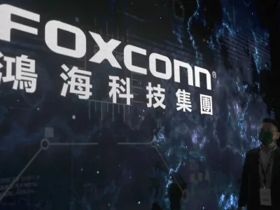 FILE - The Foxconn logo is seen during the Hon Hai Tech Day at the Nangang Exhibition Center in Taipei, Taiwan, on Oct. 18, 2022. Employees at the world's biggest Apple iPhone factory have been beaten and detained in protests over contract disputes amid anti-virus controls, according to employees and videos posted on social media Wednesday, Nov. 23, 2022. Videos that said they were filmed at the factory in the central city of Zhengzhou, China, showed thousands of people in masks facing police in white protective suits with riot shields. (AP Photo/Chiang Ying-ying, File)