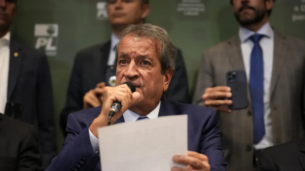 Valdemar Costa Neto, the leader of President Jair Bolsonaro's Liberal Party, center, speaks during a press conference regarding an investigation carried out by the party pointing out inconsistencies in voting machines used in the general elections, in Brasilia, Brazil, Tuesday, Nov. 22, 2022. Bolsonaro is contesting his defeat in the October election and calling on the electoral authority to annul votes cast on more than half of electronic voting machines used. (AP Photo/Eraldo Peres)