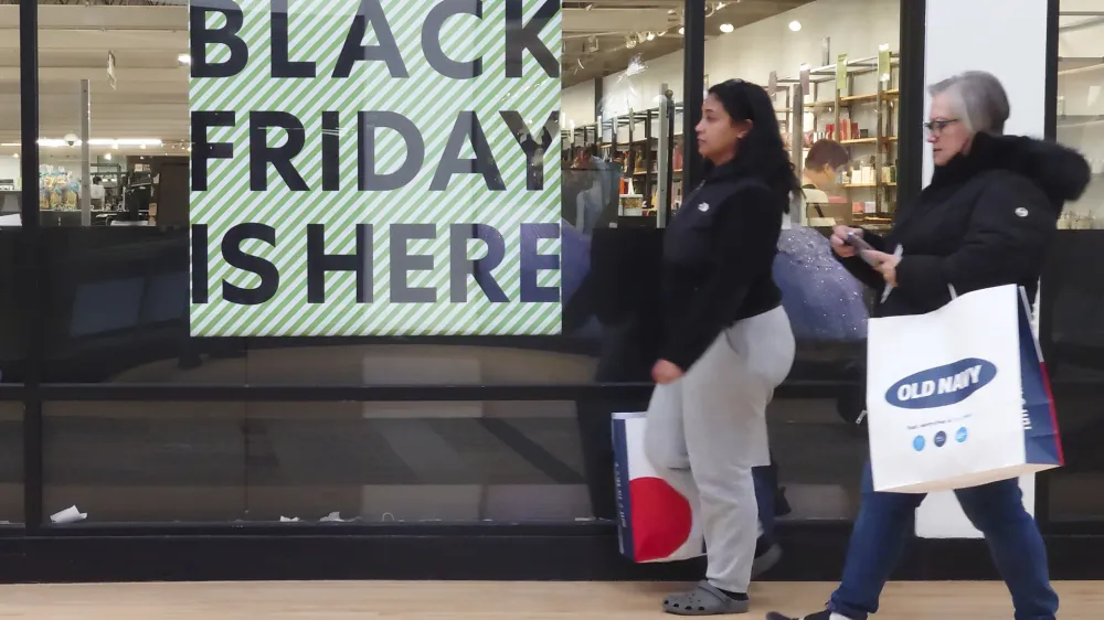 A "Black Friday" sign is posted at a retail location in Philadelphia, Monday, Nov. 21, 2022. Bargain hunting is back with full force heading into the holidays. But inflation is limiting how much of a deal consumers will be getting. (AP Photo/Matt Rourke)