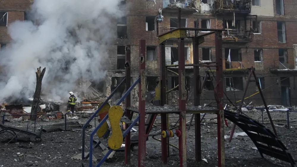 Ukrainian State Emergency Service firefighters work to extinguish a fire at the scene of a Russian shelling in the town of Vyshgorod outside the capital Kyiv, Ukraine, Wednesday, Nov. 23, 2022. Authorities reported power outages in multiple cities of Ukraine, including parts of Kyiv, and in neighboring Moldova after renewed strikes Wednesday struck Ukrainian infrastructure facilities. (AP Photo/Efrem Lukatsky)