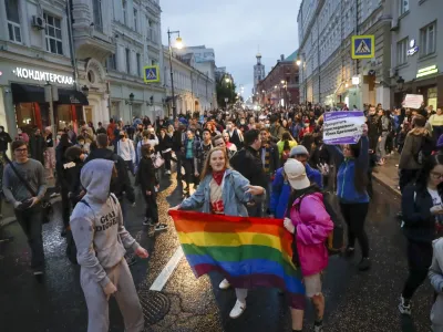 FILE - LGBTQ activists hold a rainbow-colored flag at a rally to collect signatures to cancel the results of voting on amendments to the Constitution, in Pushkin Square, Moscow, Russia, Wednesday, July 15, 2020. Russian lawmakers on Thursday, Nov. 24, 2022 gave their final approval to a bill that significantly expands restrictions on activities seen as promoting gay rights in the country, another step in a years-long crackdown on the country's embattled LGBTQ community. (AP Photo, File)