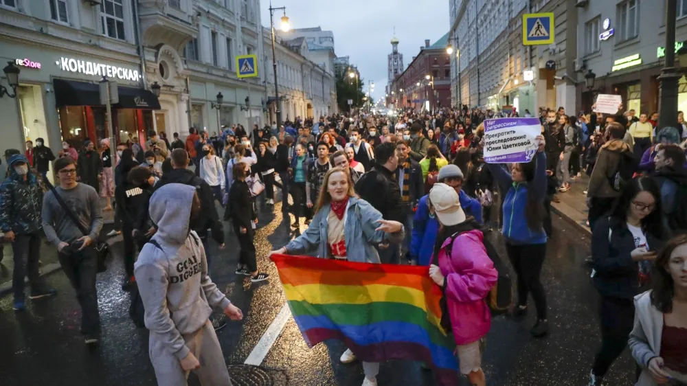 FILE - LGBTQ activists hold a rainbow-colored flag at a rally to collect signatures to cancel the results of voting on amendments to the Constitution, in Pushkin Square, Moscow, Russia, Wednesday, July 15, 2020. Russian lawmakers on Thursday, Nov. 24, 2022 gave their final approval to a bill that significantly expands restrictions on activities seen as promoting gay rights in the country, another step in a years-long crackdown on the country's embattled LGBTQ community. (AP Photo, File)