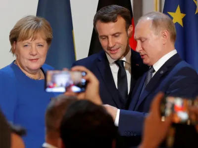 FILE PHOTO: German Chancellor Angela Merkel, French President Emmanuel Macron and Russia's President Vladimir Putin attend a joint news conference after a Normandy-format summit in Paris, France December 9, 2019. REUTERS/Charles Platiau/Pool/File Photo