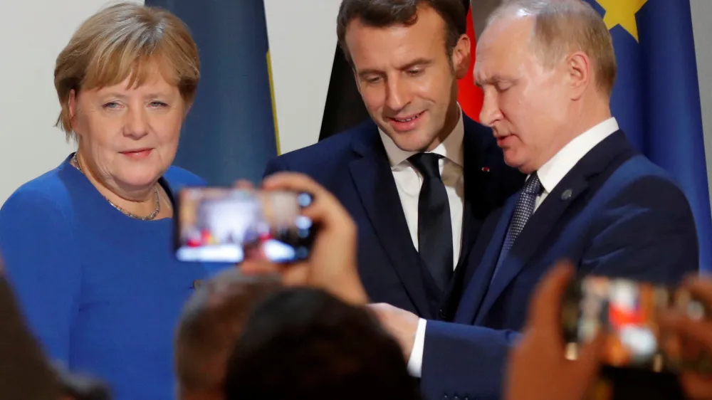 FILE PHOTO: German Chancellor Angela Merkel, French President Emmanuel Macron and Russia's President Vladimir Putin attend a joint news conference after a Normandy-format summit in Paris, France December 9, 2019. REUTERS/Charles Platiau/Pool/File Photo