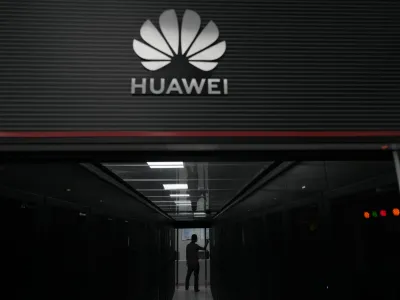 A technician stands at the entrance to a Huawei 5G data server center at the Guangdong Second Provincial General Hospital in Guangzhou, in southern China's Guangdong province on Sept. 26, 2021. The U.S. is banning the sale of communications equipment made by Chinese companies Huawei and ZTE and restricting the use of some China-made video surveillance systems, citing an "unacceptable risk" to national security. The 5-member Federal Communications Commission said Friday, Nov. 25, 2022 it has voted unanimously to adopt new rules that will block the importation or sale of certain technology products that pose security risks. (AP Photo/Ng Han Guan)